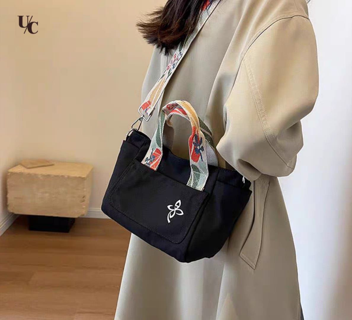 Canvas bucket bag with front zip pocket and bottle pocket detail
