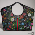 Women's floral print net tote bag with black leather trim and detachable pouch
